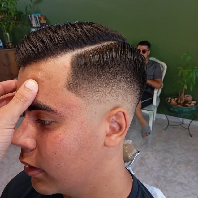 Precision men's skin fade with sharp parting